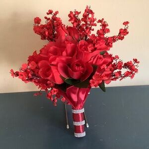Red roses, rosebuds and red baby’s breath bridal bouquet